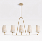 Product shot on a plain white background: this Clérachic chandelier's triangular brass stem rises to a low oval rail of five shades.