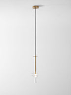 A single gold-stemmed Clérachic pendant in clear glass hangs unlit on a shorter drop against a plain white backdrop.