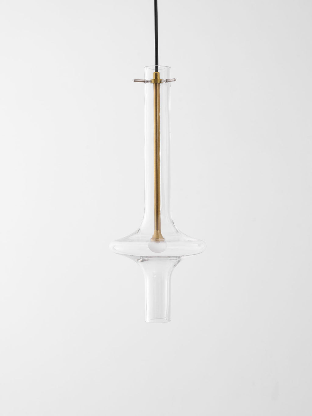 A close view of this Clérachic pendant shows its gold-toned stem and crossbar fitting against clear glass, unlit.
