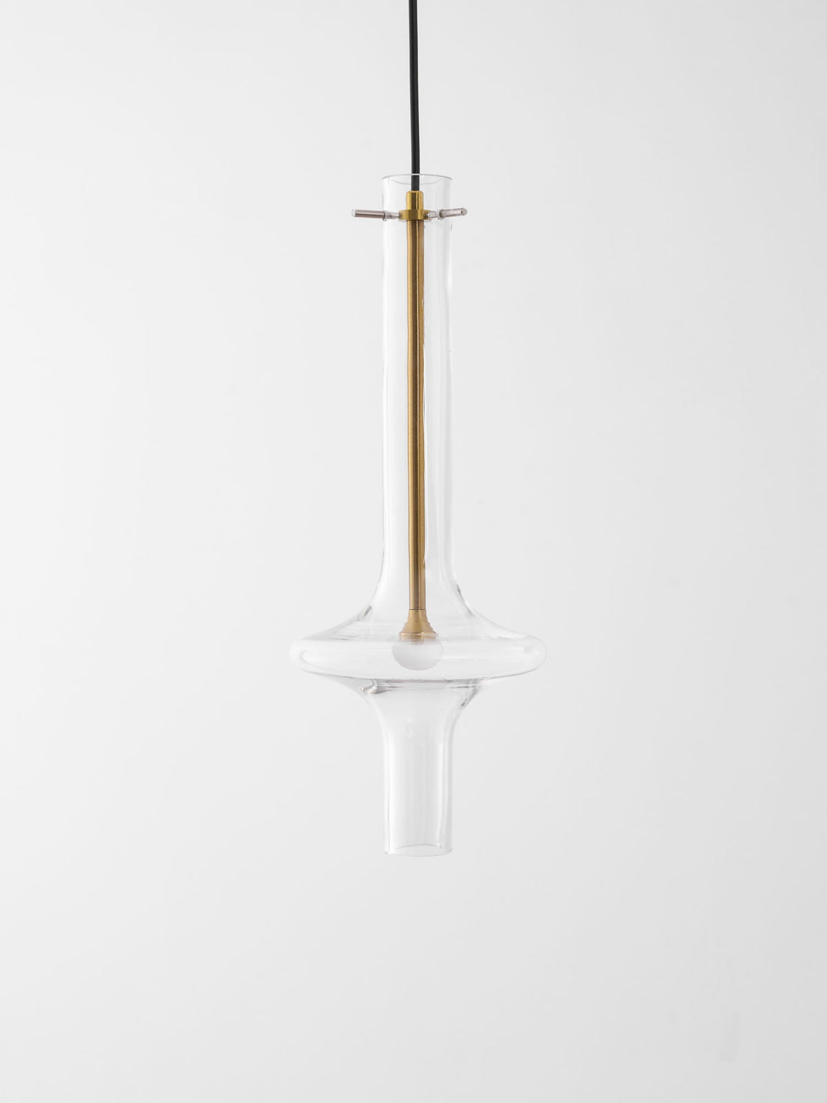 A close view of this Clérachic pendant shows its gold-toned stem and crossbar fitting against clear glass, unlit.