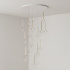 Clérachic pendants in mixed clear and tinted glass spiral downward from a round canopy, lit in the corner of a grey room.