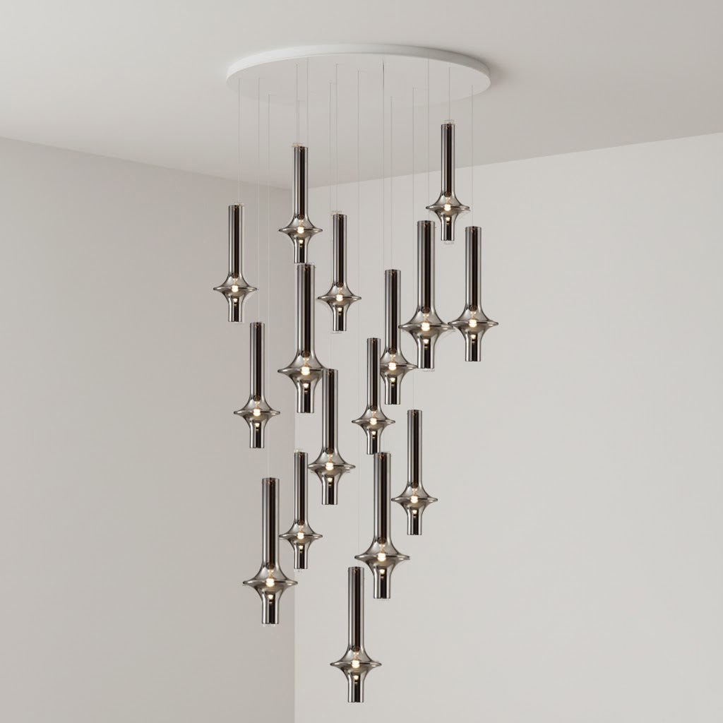 Black-stemmed Clérachic pendants trail low in a spiralling pattern from a round canopy, lit in the corner of a grey room.