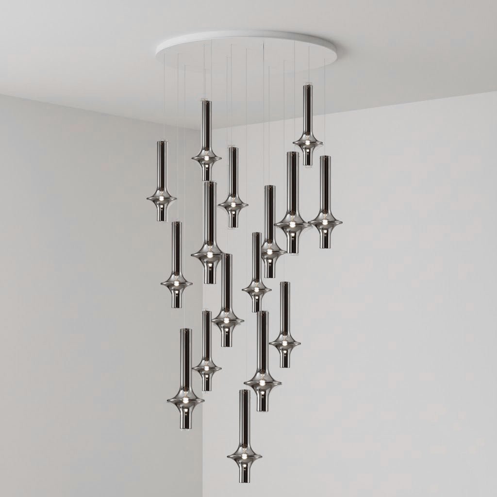 Black-stemmed Clérachic pendants cascade from a round canopy against a darker grey backdrop, glass heads lit in the room corner.