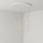 A dense cascade of lit Clérachic pendants in clear glass fills the corner of a plain grey room, dropping from a round canopy.