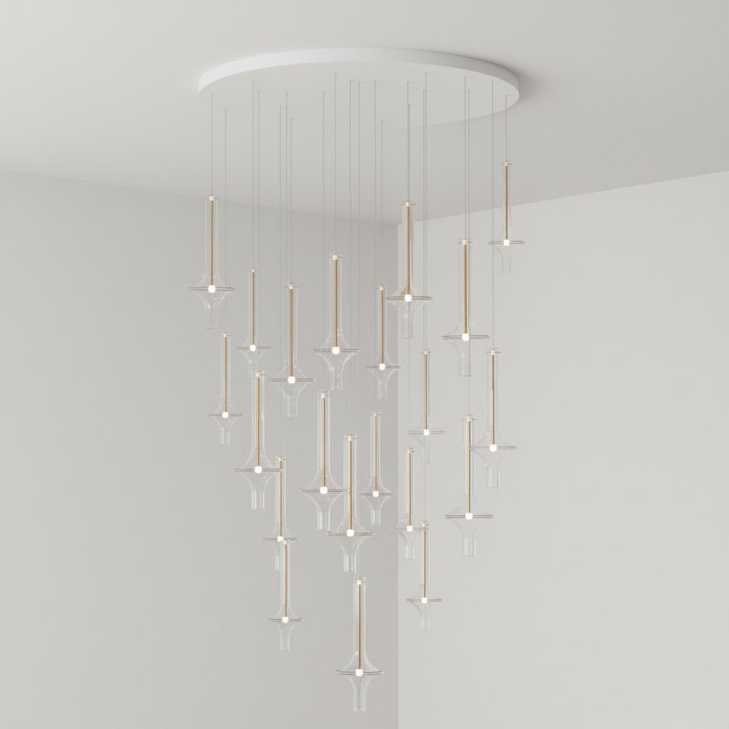 A dense cascade of lit Clérachic pendants in clear glass fills the corner of a plain grey room, dropping from a round canopy.
