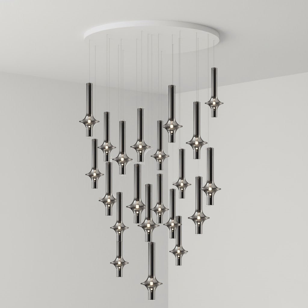 A large, dense arrangement of black-stemmed Clérachic pendants drops from a round canopy, lit in the corner of a grey room.