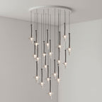 Black-stemmed Clérachic pendants gather densely near the centre of the cluster, lit in clear glass in a grey corner room.