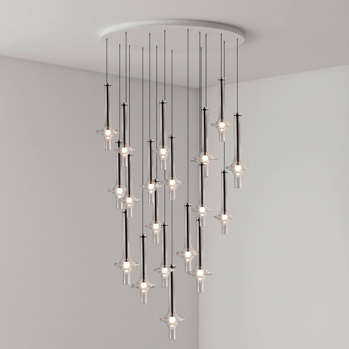 Black-stemmed Clérachic pendants gather densely near the centre of the cluster, lit in clear glass in a grey corner room.