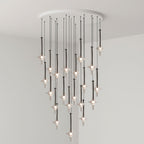 Black-stemmed Clérachic pendants drop in tight tiers from a round canopy, lit in clear glass in a grey corner room.