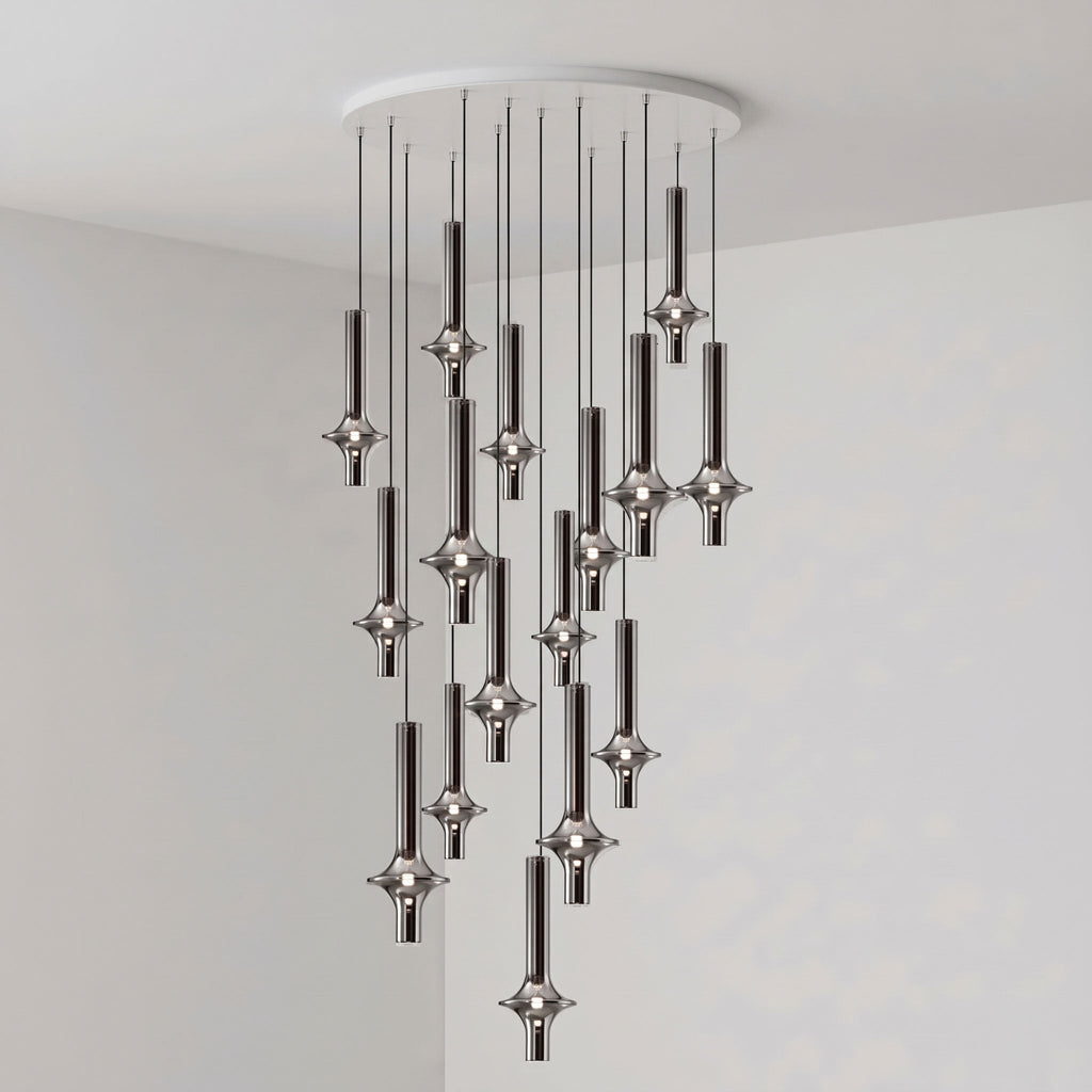 Black-stemmed Clérachic pendants hang unlit in a dense cluster from a round canopy, in the corner of a plain grey room.