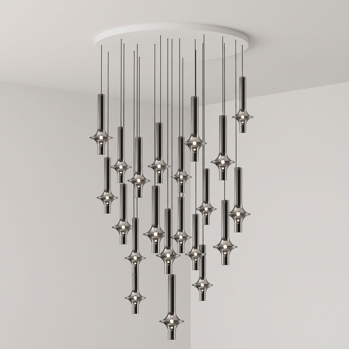 A dense cluster of lit black-stemmed Clérachic pendants drops from a round canopy in the corner of a grey room.