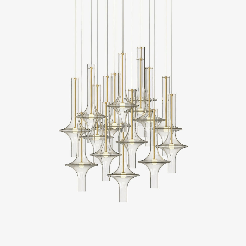 Many gold-stemmed pendants in clear and smoky glass hang together in this Clérachic cluster shot on a plain white backdrop.