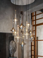 A wider view shows lit Clérachic pendants clustered in a stone-walled room, beside a timber lattice door and stone sculpture.