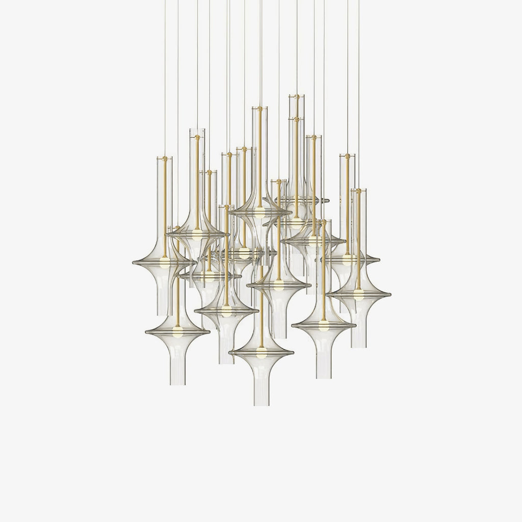A dense cluster of gold-stemmed Clérachic pendants in clear glass is shown unlit against a plain cream backdrop.