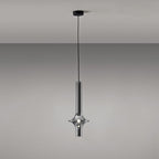 A single black-stemmed Clérachic pendant in smoky grey glass hangs unlit against a plain grey backdrop, its black canopy visible above.