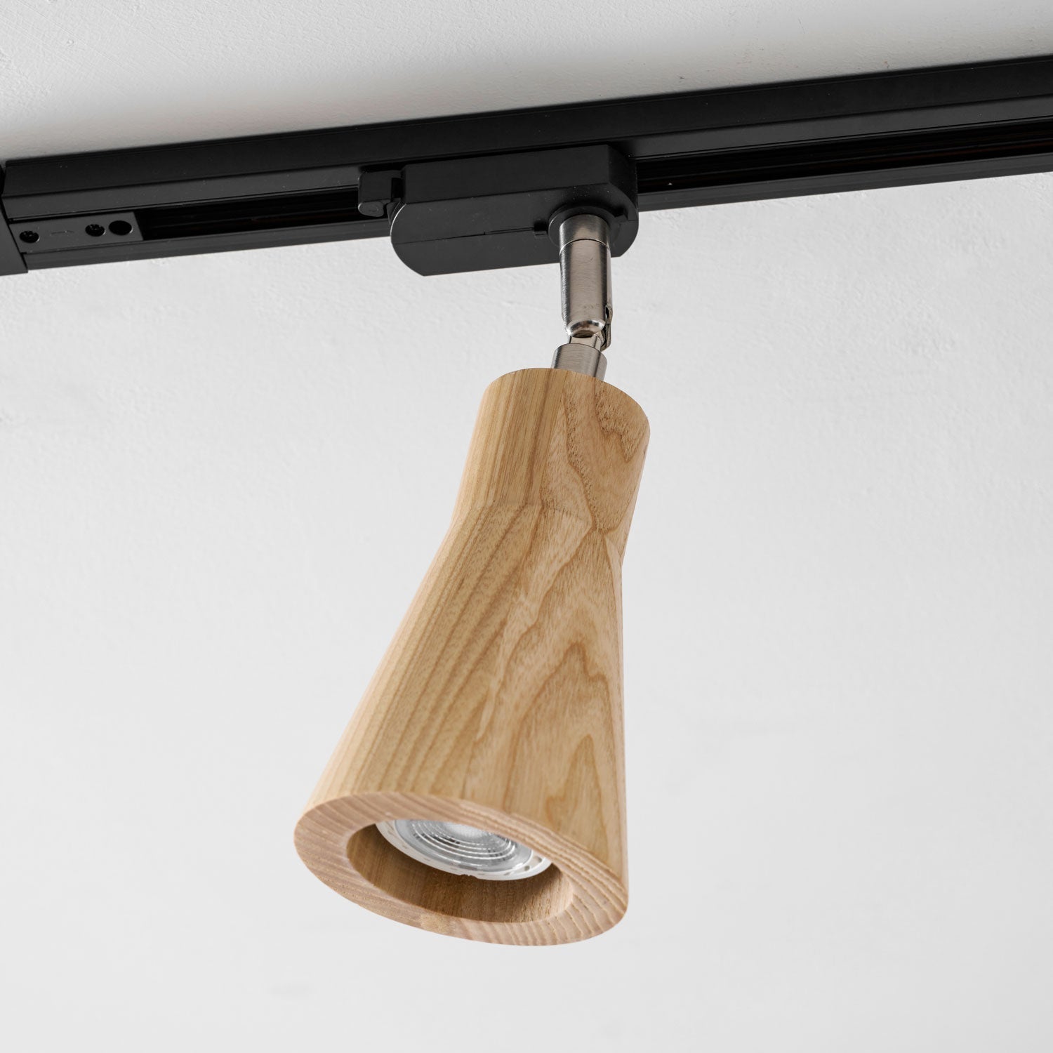 Wood track ceiling lamp with a wood canopy in a warm interior
