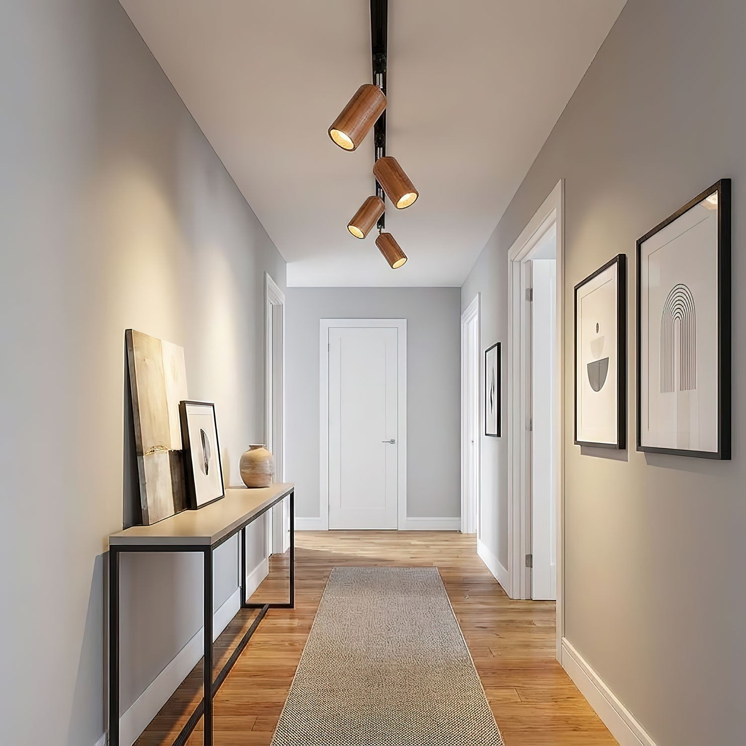 Wood track ceiling lamp lighting an open-plan living space