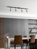 Wood track ceiling lamp with warm spotlights over a seating area