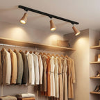 Wood track ceiling lamp with adjustable heads in a styled interior