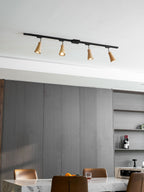 Wood track ceiling lamp with adjustable heads over a workspace