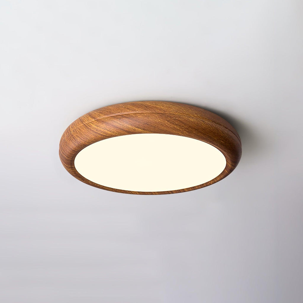 Round flush mount ceiling light in walnut grain seen below