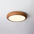 Round flush mount ceiling light in walnut grain seen below