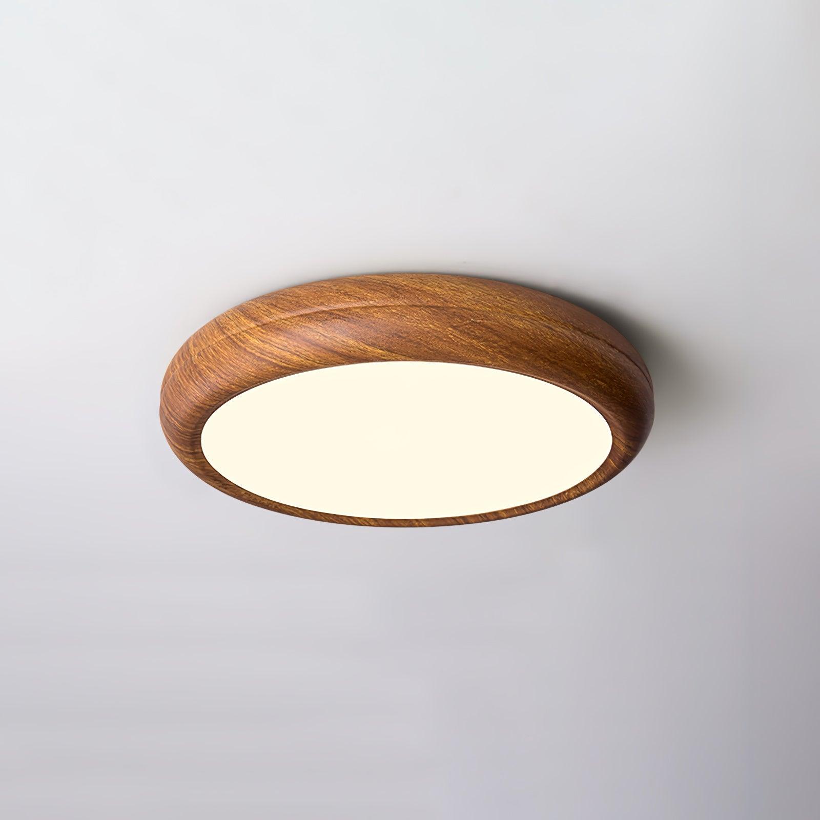 Round flush mount ceiling light in walnut grain seen below