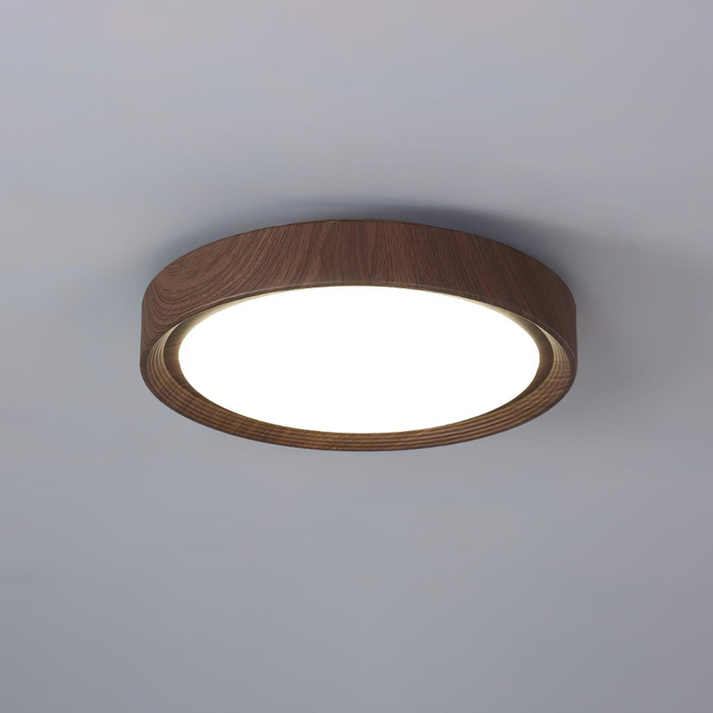 Walnut round ceiling light lit warmly in a living room