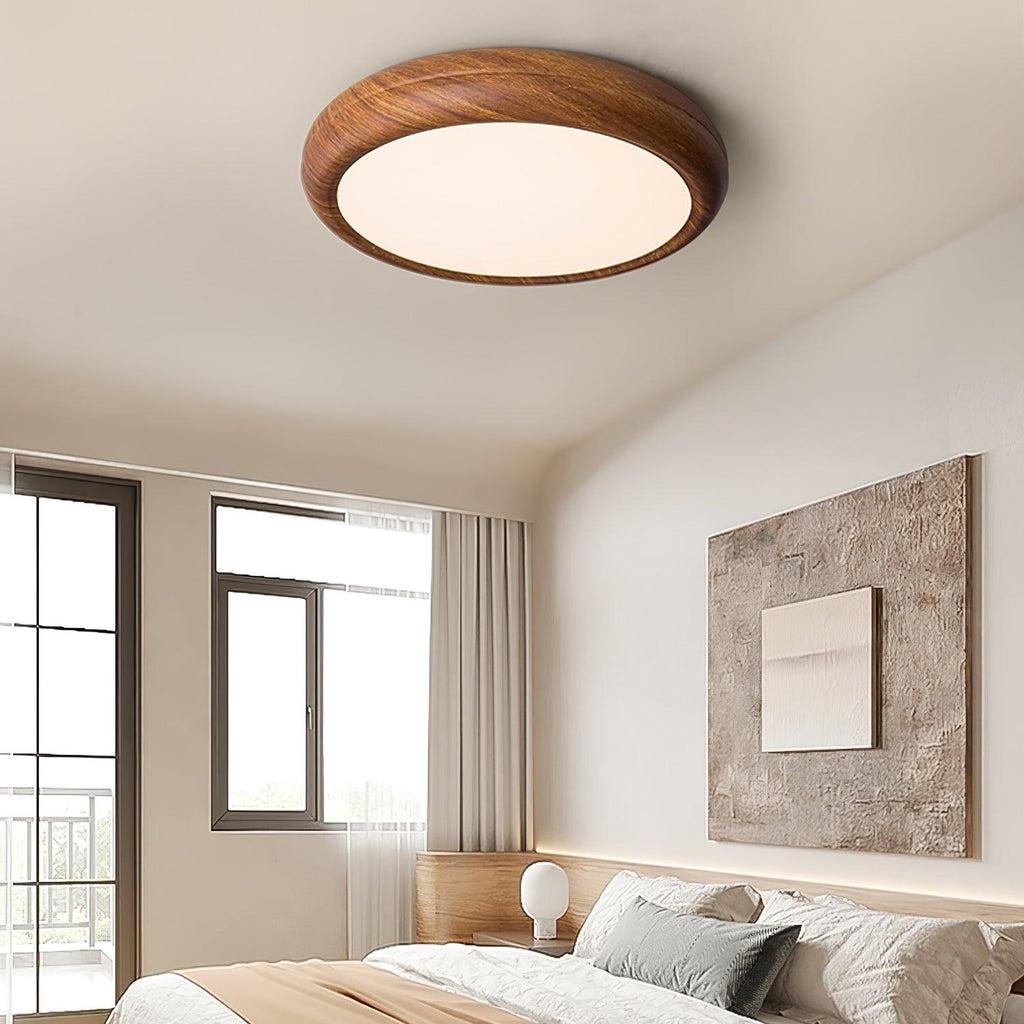 Wood grain ceiling light with white diffuser in a hall