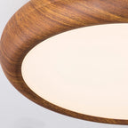 Wood grain flush mount ceiling light lit in a bedroom