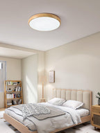 Round walnut ceiling light shown in a neutral interior