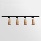 Wood track ceiling lamp casting directional light over a dining area