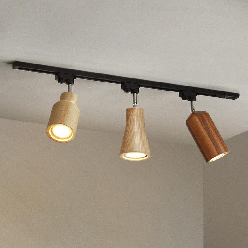 Wood track ceiling lamp lighting a workspace with focused beams
