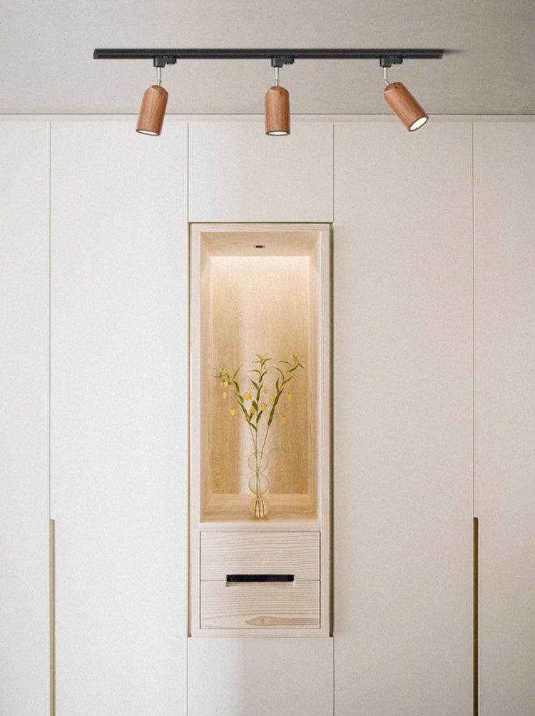 Wood track ceiling lamp with adjustable heads in a neutral room