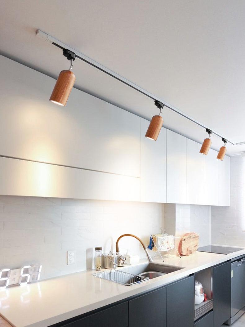 Wood track ceiling lamp with four heads over a long counter