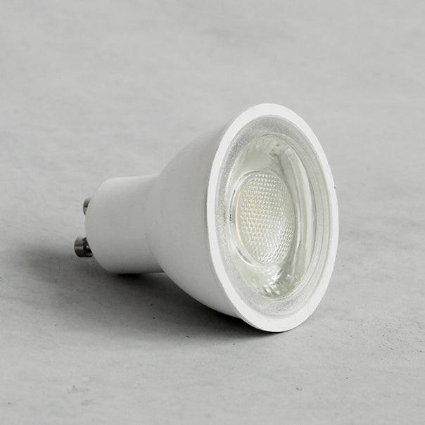 Wood track ceiling lamp directing light over a dining table