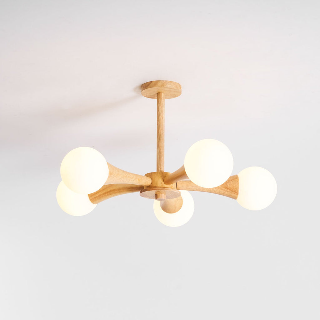 Rotated so its globes cluster to the right, this Clérachic chandelier sits unlit on a plain grey background.