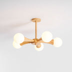Rotated so its globes cluster to the right, this Clérachic chandelier sits unlit on a plain grey background.