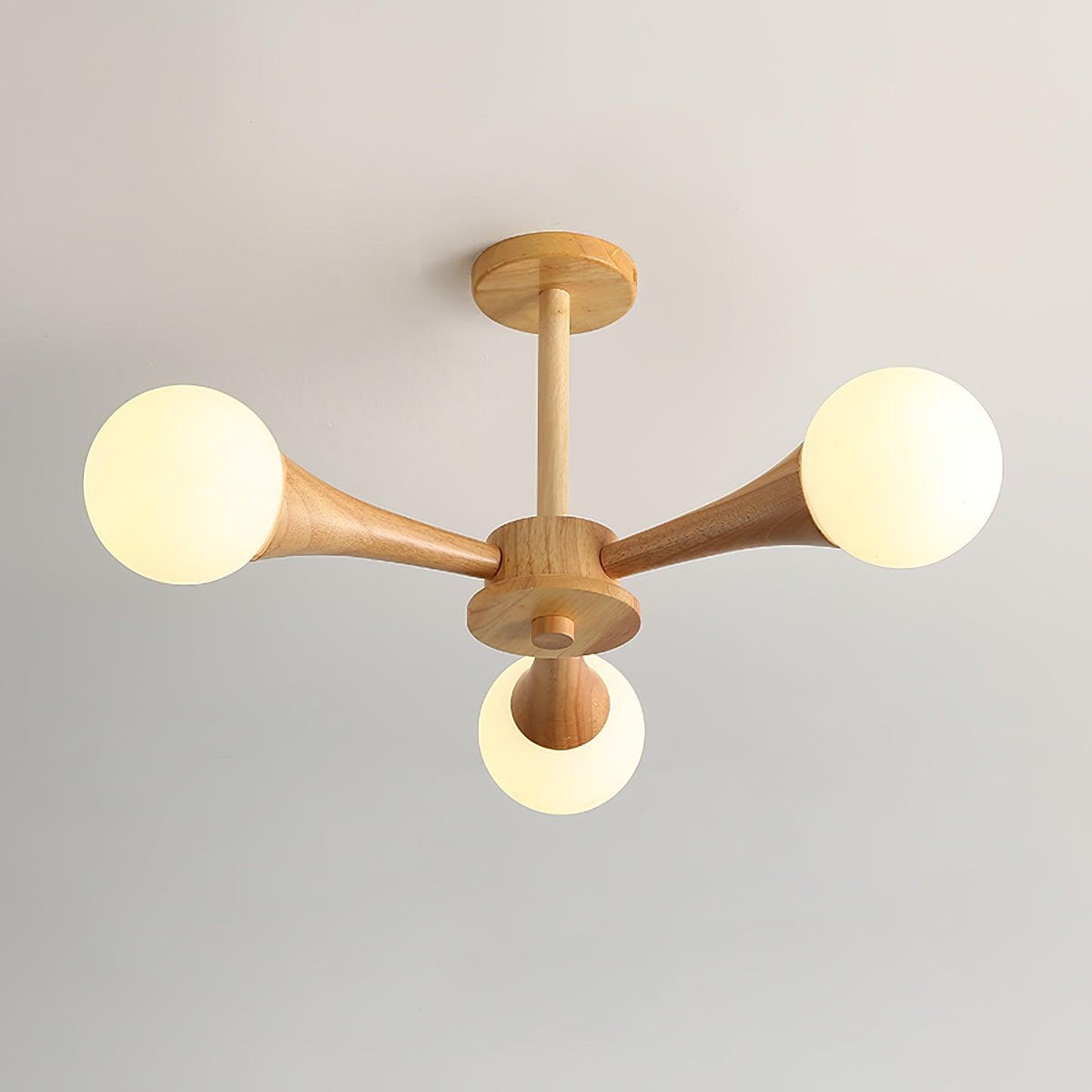Viewed from below on a plain backdrop, this Clérachic chandelier's five opal globes sit unlit on their pale wood arms.