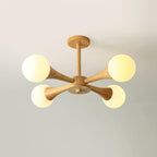 Photographed front-on against a soft grey-beige background, this Clérachic chandelier's pale wood frame and opal globes sit unlit.