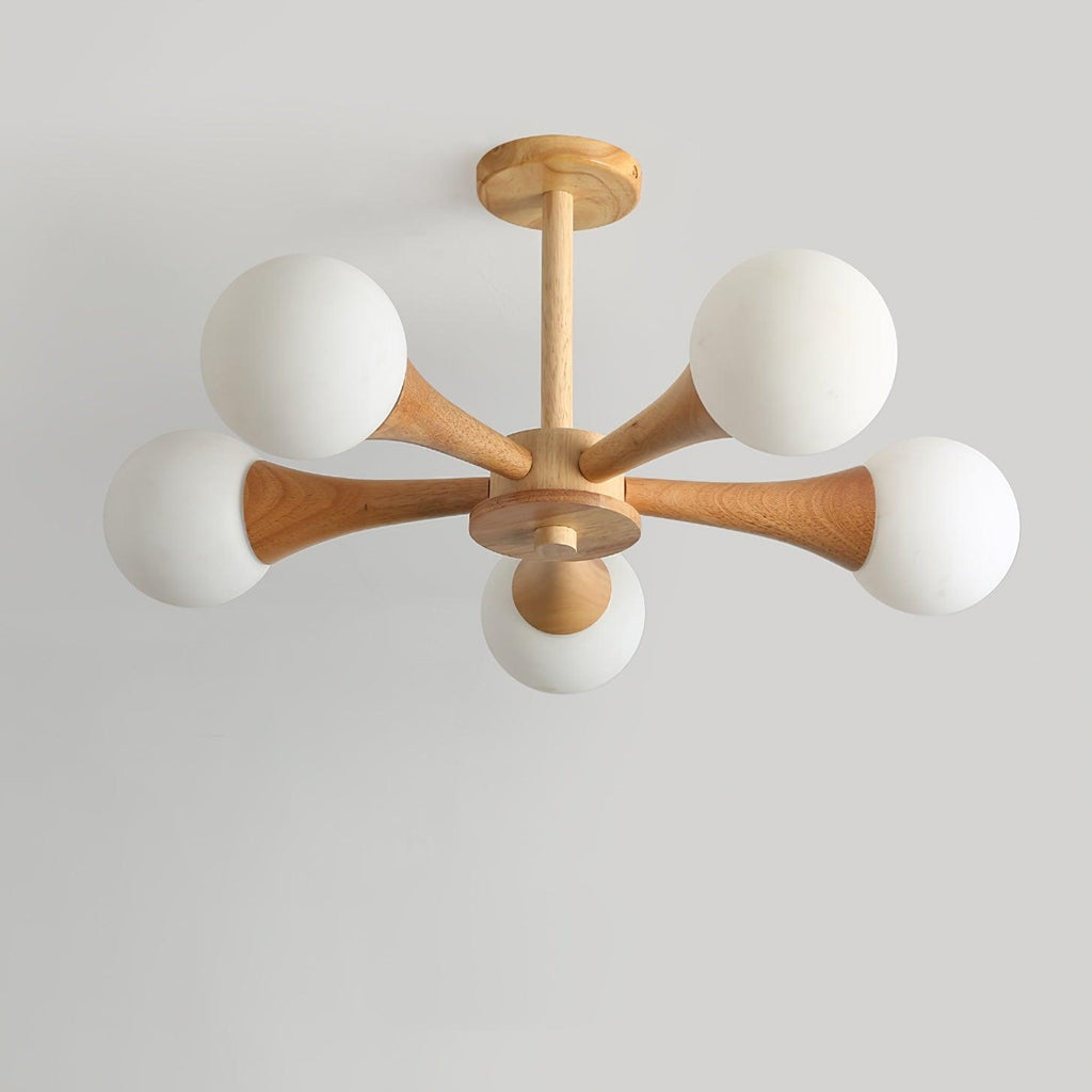 Unlit on a plain grey background, this Clérachic chandelier shows its pale wood arms and five opal glass globes from another angle.
