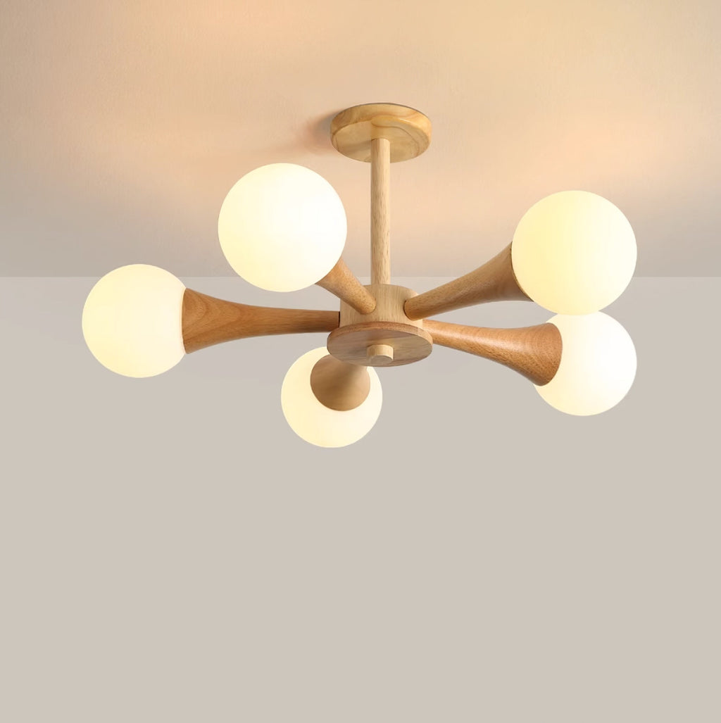 Close view of the ceiling mount on a pale pink-grey backdrop, this Clérachic chandelier's wood canopy and upper arms shown unlit.