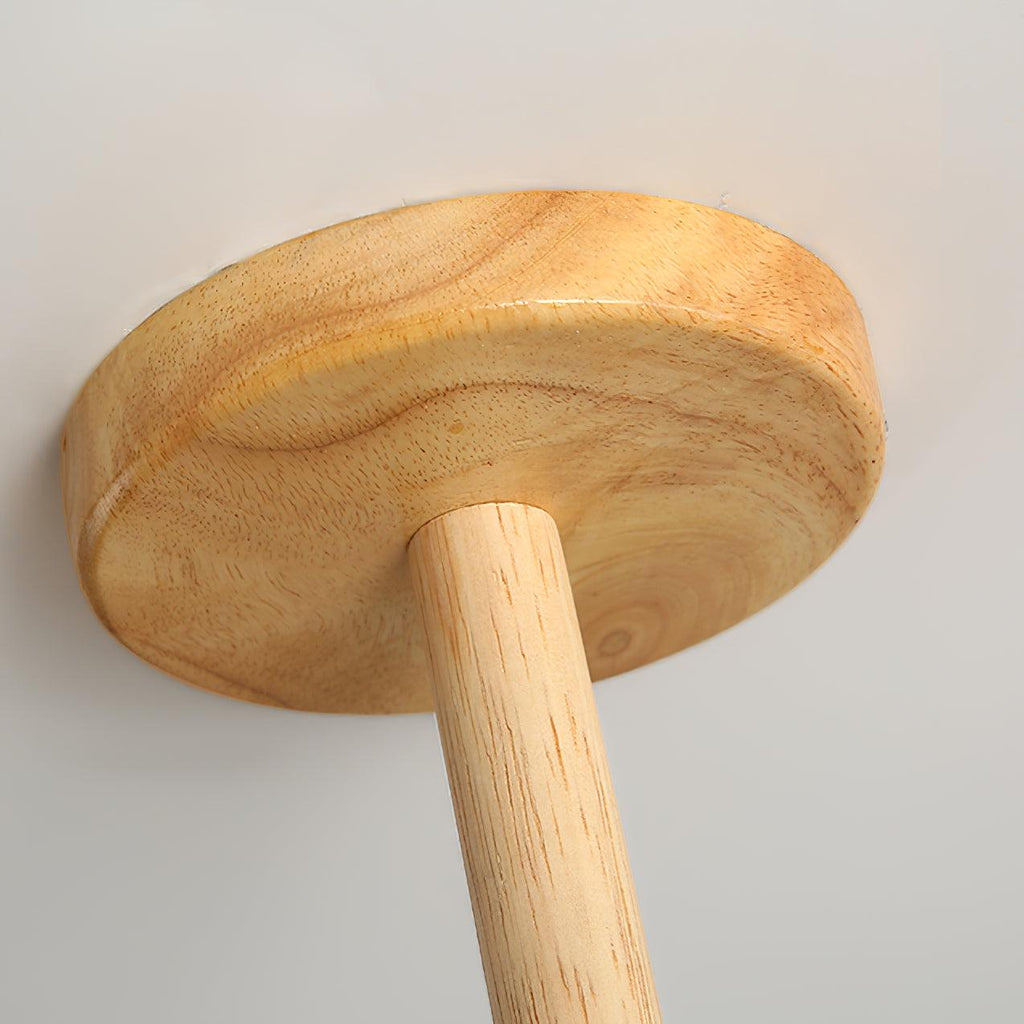 Looking up at the wood ceiling canopy of this Clérachic chandelier, the grain and mounting rod shown in close detail.