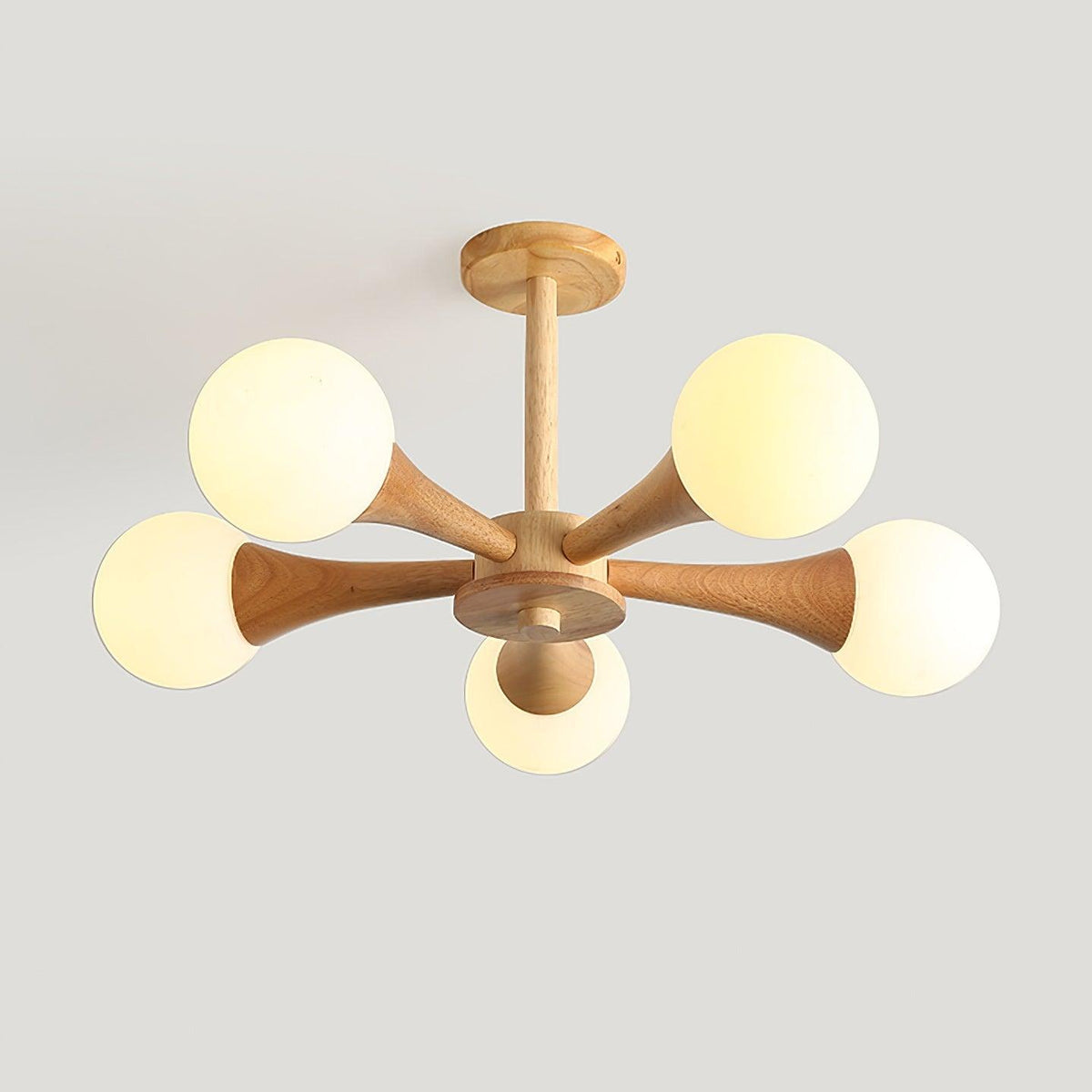 Shown at a slight angle on a plain grey background, this Clérachic chandelier's pale wood arms hold five unlit opal globes.