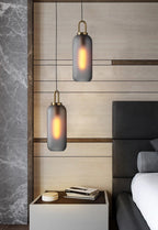 Glass pendant light cluster at mixed cable lengths over a table
