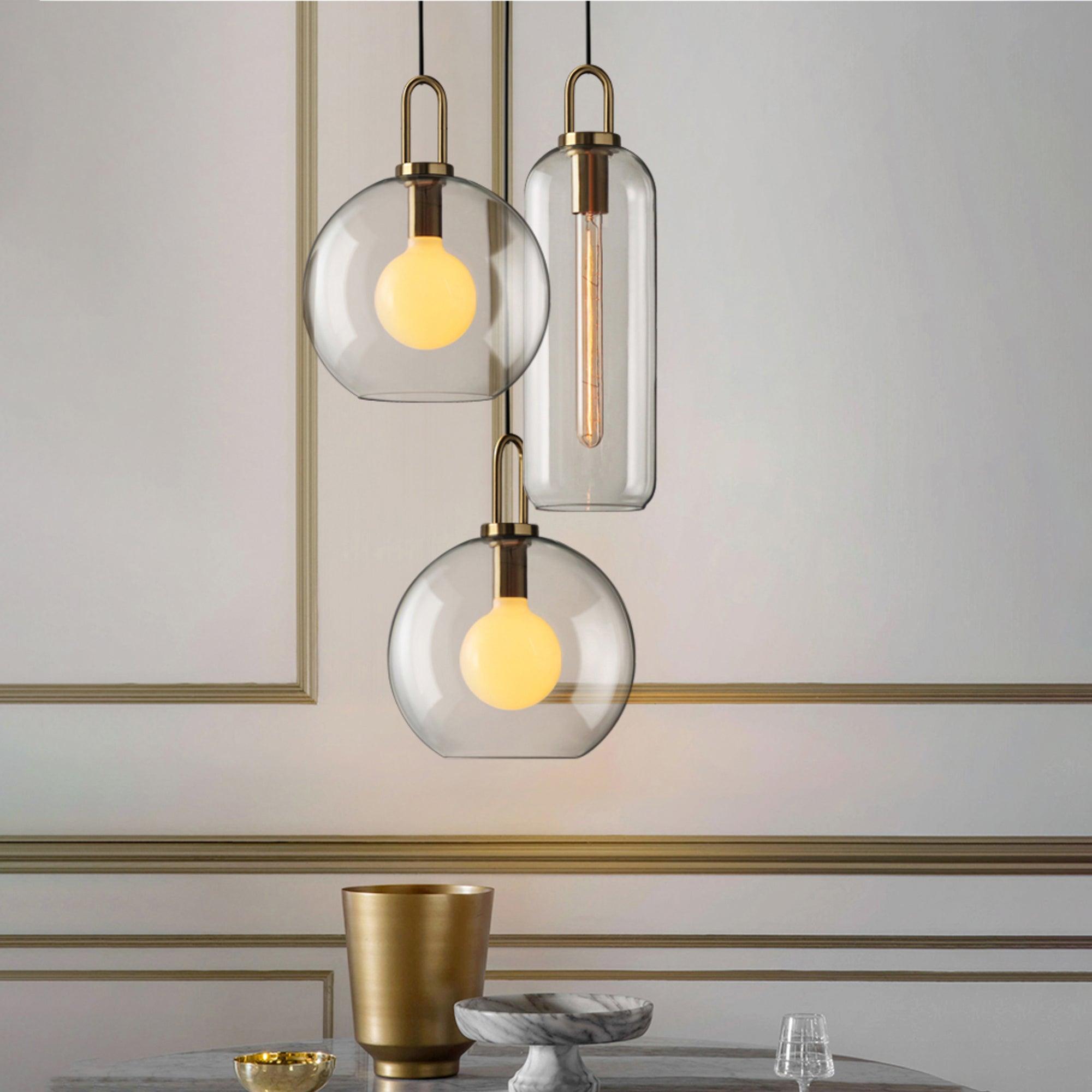 Glass pendant light hanging in a styled interior with warm light
