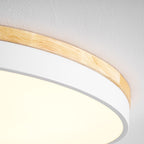 Circular wood ceiling lamp lit gently above a relaxed living area