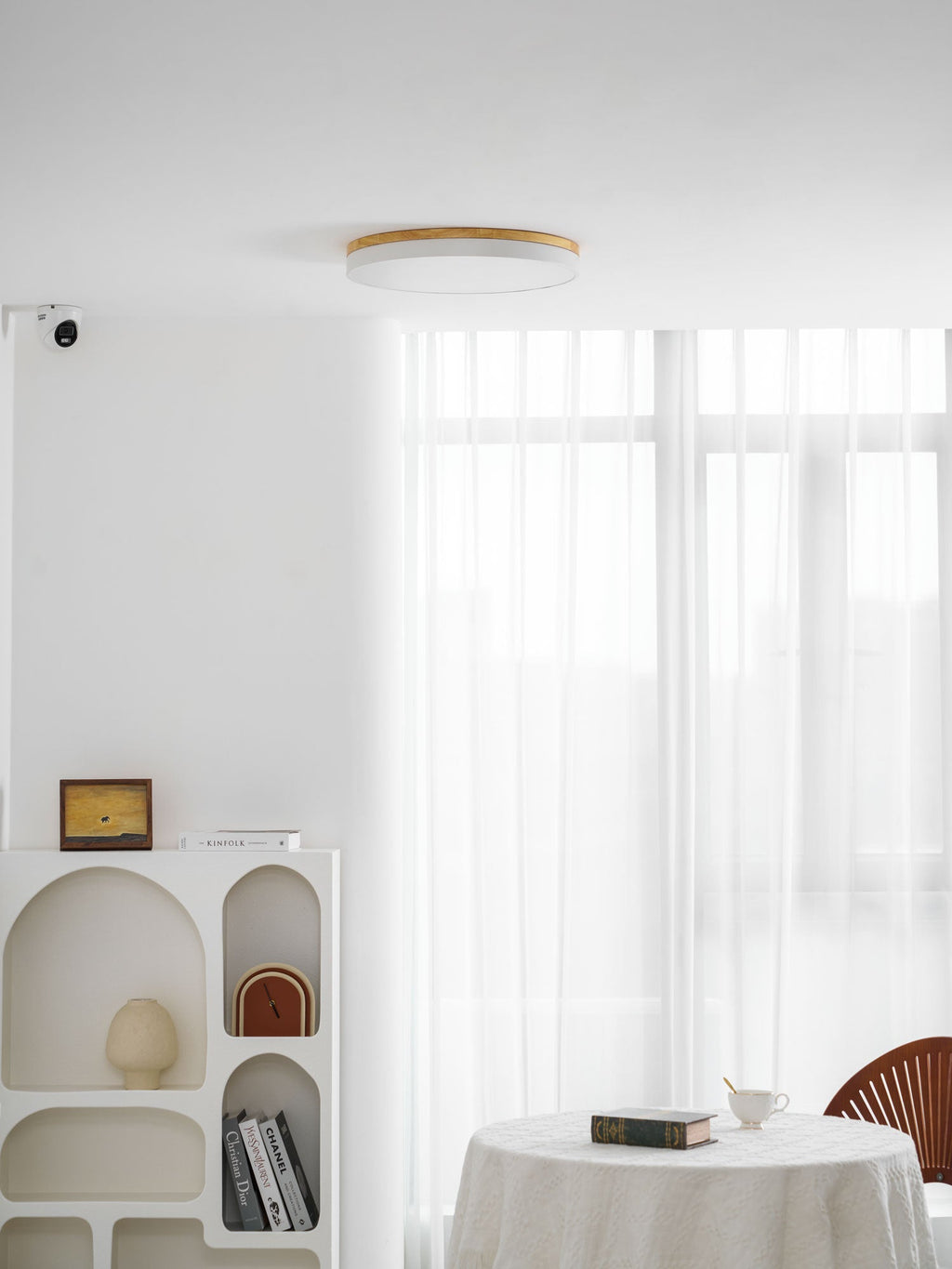 Circular wood ceiling lamp shown in a white finish flush to the ceiling