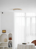 Circular wood ceiling lamp shown in a white finish flush to the ceiling