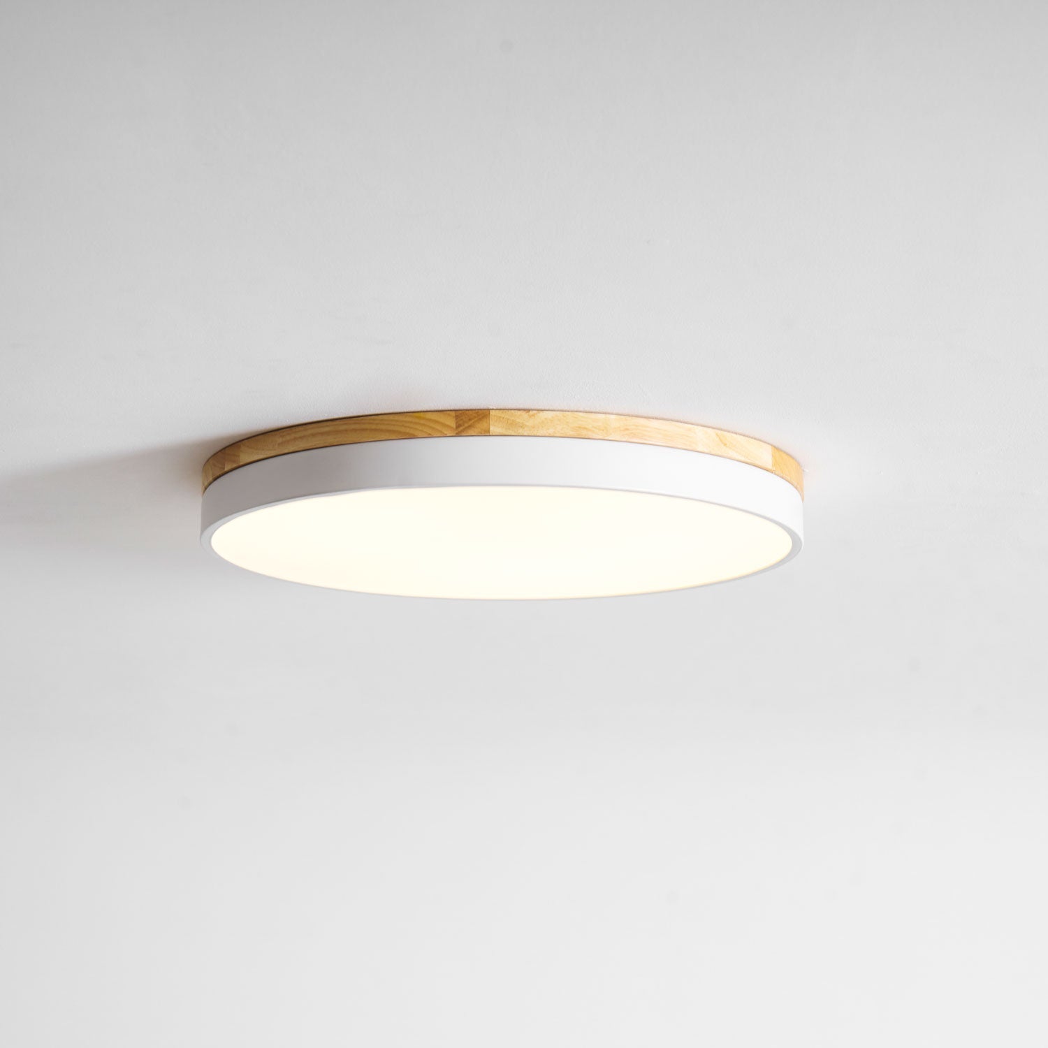 Circular wood ceiling lamp from below highlighting even illumination